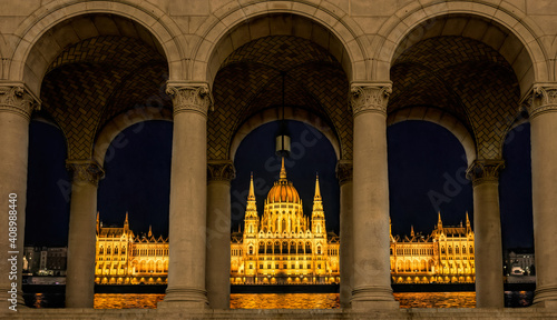 Nice night view from the window. Night panorama of shining Budapest. Elaborately decorated Hungarian parliament building with spectacular lighting. Nigtscape of the ancient european city