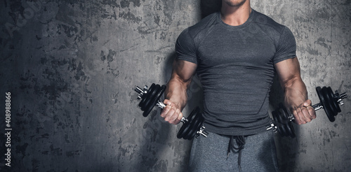 Bodybuilder doing biceps curls with dumbbells