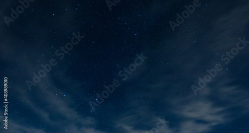 Starry night sky in North Carolina with light clouds blowing by very slowly.