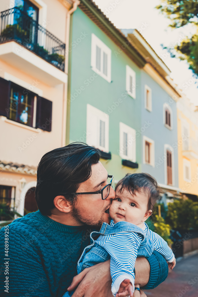 Adorable portrait of a young father hugging his baby Adorable portrait of a young father hugging his baby