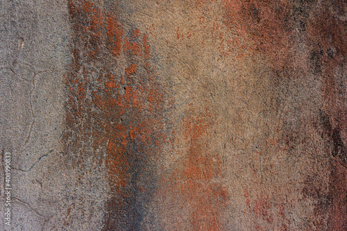 surface of the old cement plaster wall with damaged brown paint.