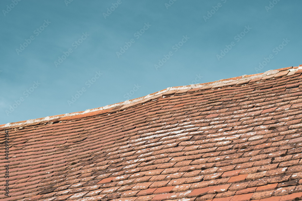 Abstract image of a house roof in contrast to the clear blue sky