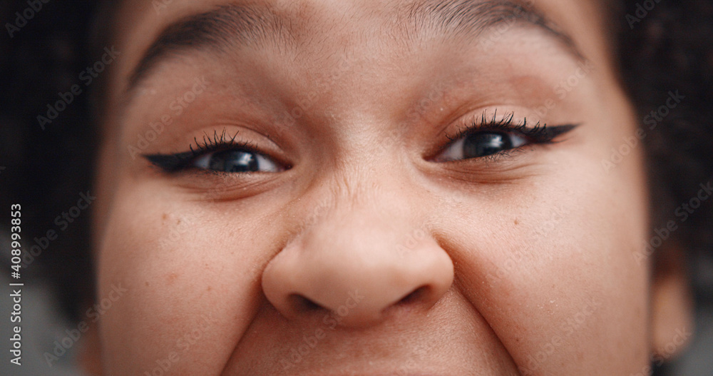 Close up of young beautiful african american woman feeling excited isolated on gray background Close up of young beautiful african american woman feeling excited isolated on gray background