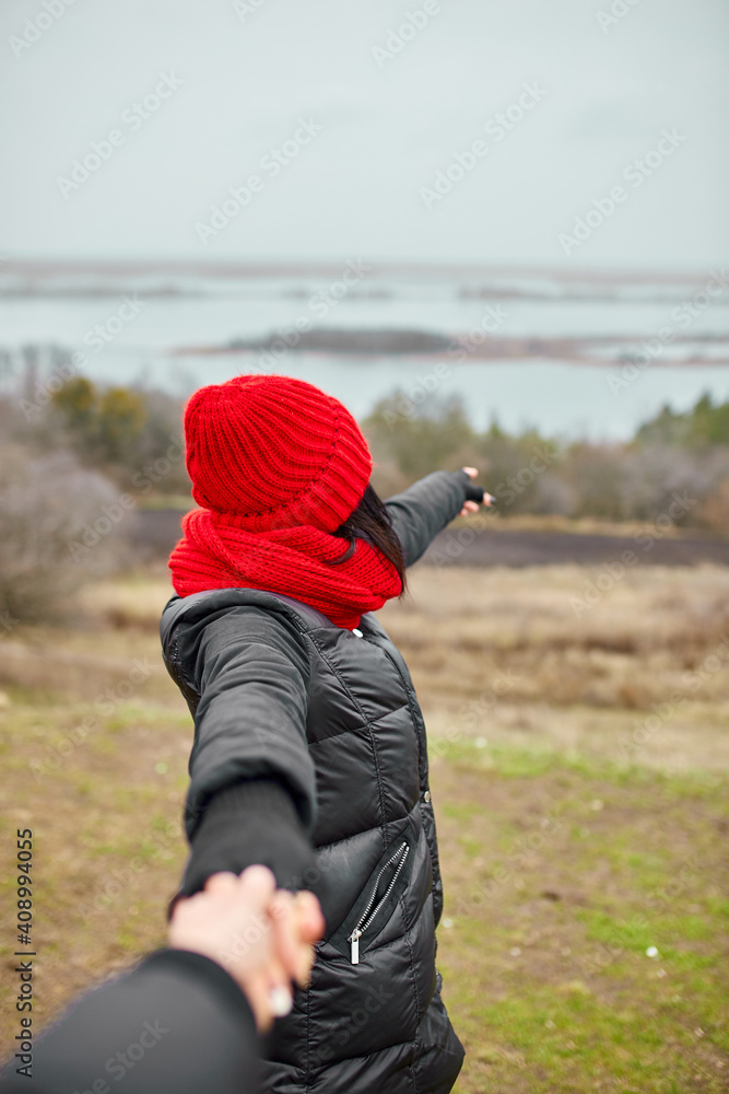 Couple travelers follow holding hands at foggy river landscape