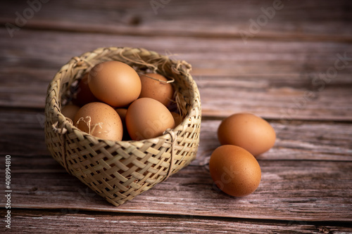 Brown chicken eggs on wooden background. Raw eggs. Fresh natural eggs.