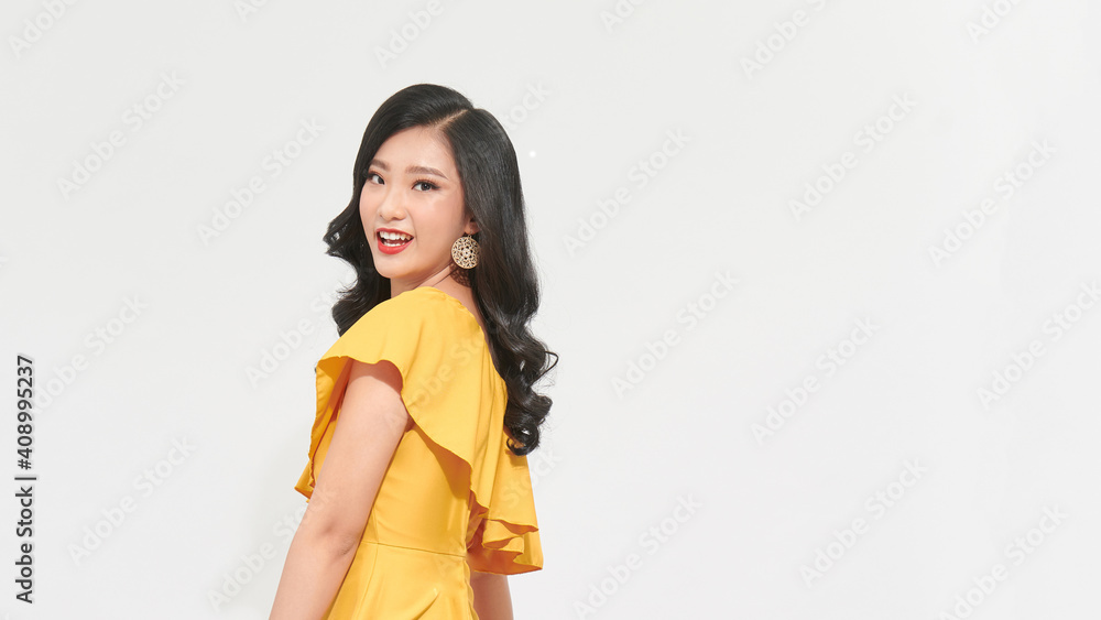 Beautiful tender woman in white dress posing by the background of white Beautiful tender woman in white dress posing by the background of white