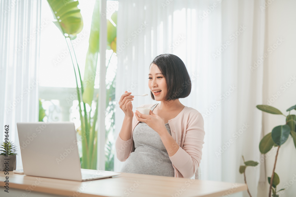 Portrait of pretty Vietnamese woman eating probiotic yogurt Portrait of pretty Vietnamese woman eating probiotic yogurt