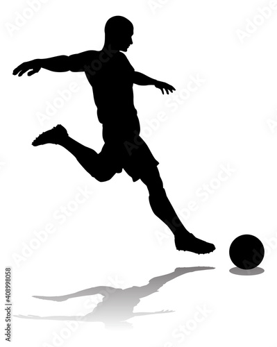 A soccer or football player in silhouette