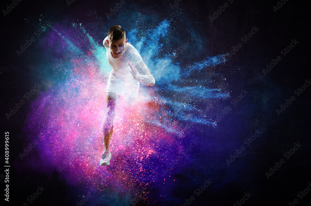 Fototapeta premium Portrait of a fitness man running on a colourful background