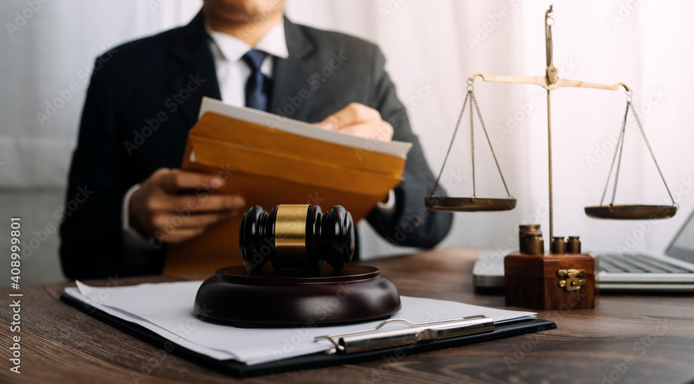 Business and lawyers discussing contract papers with brass scale on desk in office. Law, legal services, advice, justice and law concept picture with film grain effect Business and lawyers discussing contract papers with brass scale on desk in office. Law, legal services, advice, justice and law concept picture with film grain effect