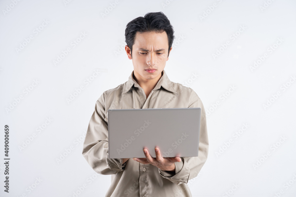 Male fabrication engineer standing typing on a white background Male fabrication engineer standing typing on a white background