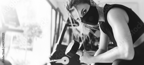 Young athletic woman wearing a prevention face mask during her fitness workout.