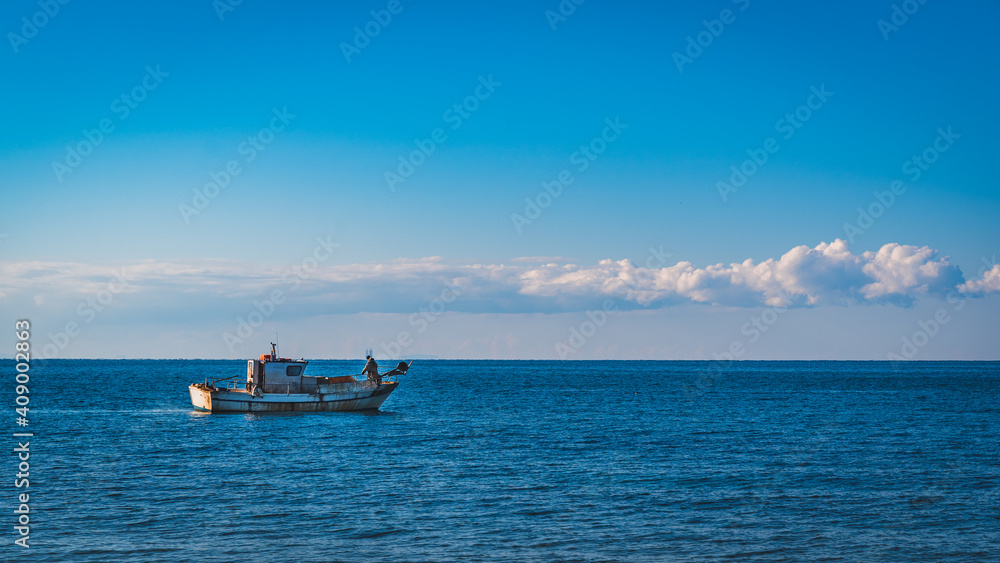 old rusty fishing boat with fisherman