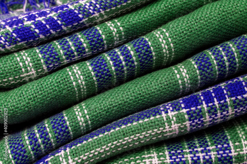 Texture of a knitted blanket. Checkered fabric close-up. Knitted plaid plaid.