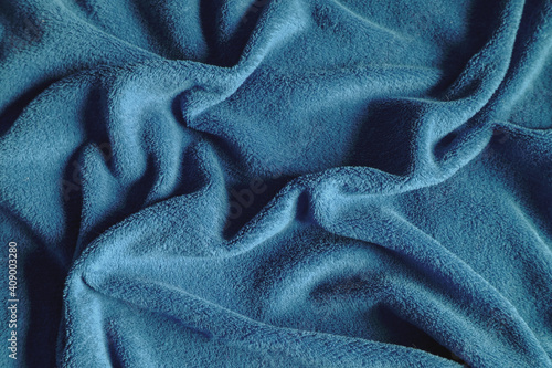 blue soft textile background with shadows and creases. top view. Copy space