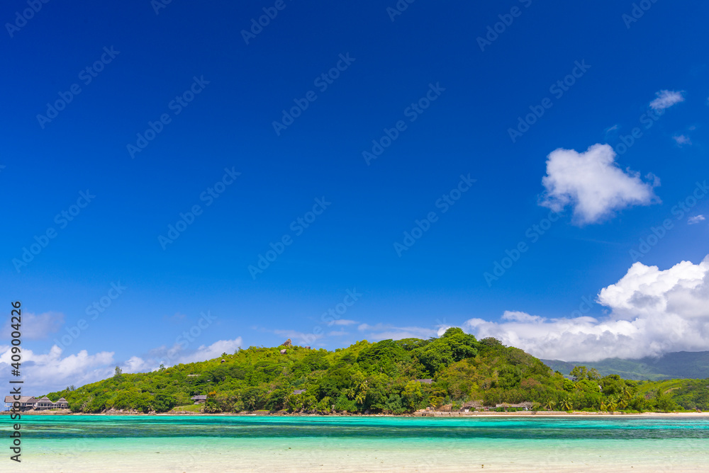 A view on the Round island from the sandbar near Ile Moyenne island in Sainte Anne Marine National Park in Seychelles
