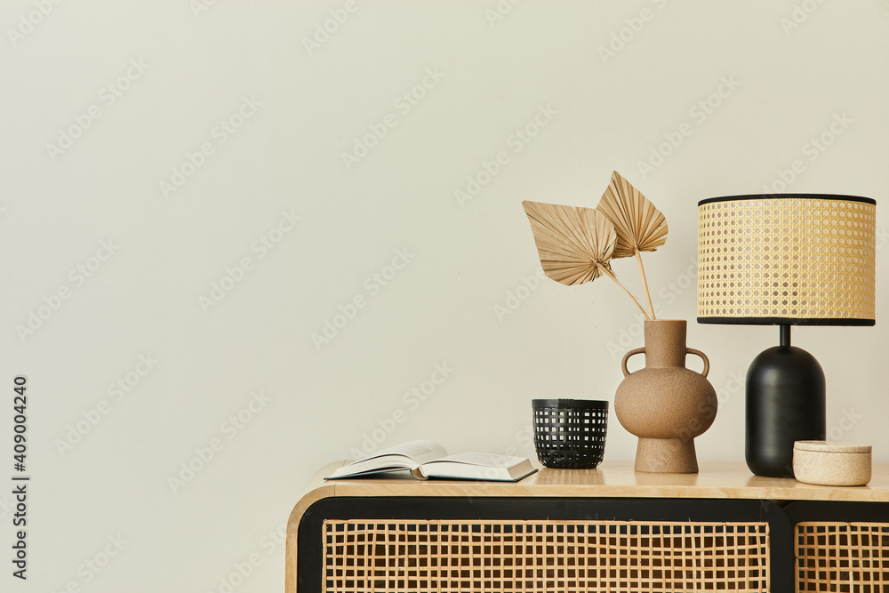 Modern scandinavian home interior with design wooden commode, dried leaf in vase, books, table lamp and personal accessories in stylish home decor. Template. Copy space. White walls. - obrazy, fototapety, plakaty 