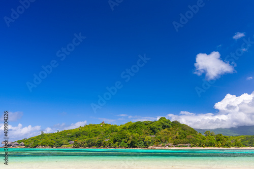 Fototapeta Naklejka Na Ścianę i Meble -  A view on the Round island from the sandbar near Ile Moyenne island in Sainte Anne Marine National Park in Seychelles