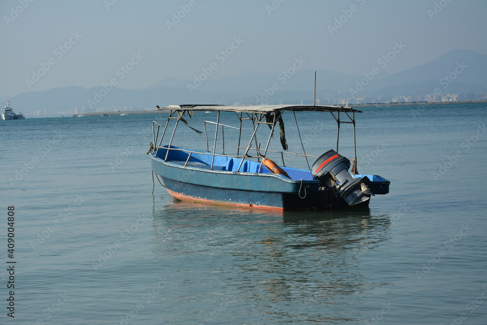 Fototapeta premium a fishing boat park at the quiet bay in sunny afternoon