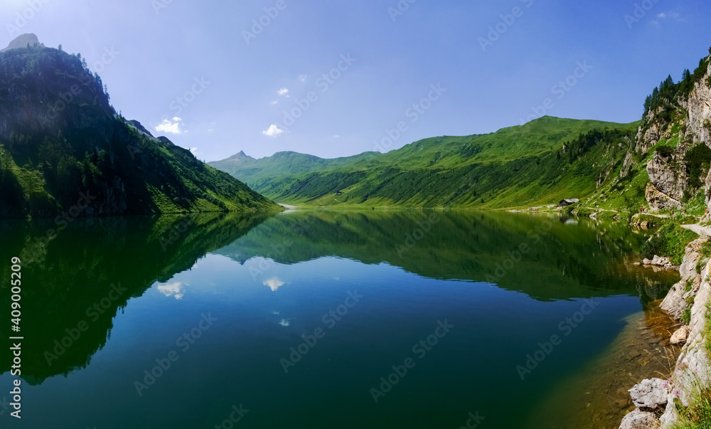 deep blue mountain lake with gorgeous reflection from the landscape panorama