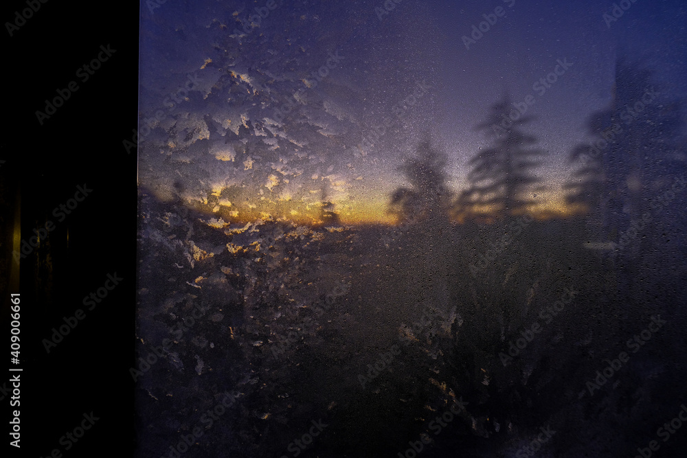 Misted window across sunset in the mountains and pine. Natural background. 