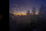 Misted window across sunset in the mountains and pine. Natural background. 