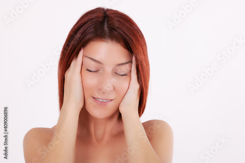 Sensual woman with clean fresh skin touching her face.