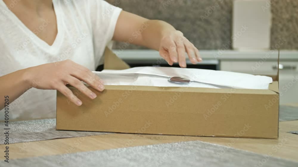 Young woman is sincerely happy about the delivered parcel. Online shopping. Young woman is sincerely happy about the delivered parcel. Online shopping.