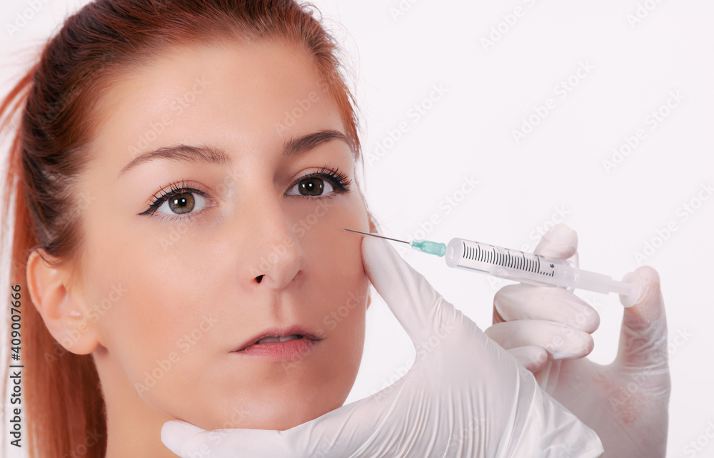 Close-up of beautiful woman treating face with with hyaluronic acid injection.