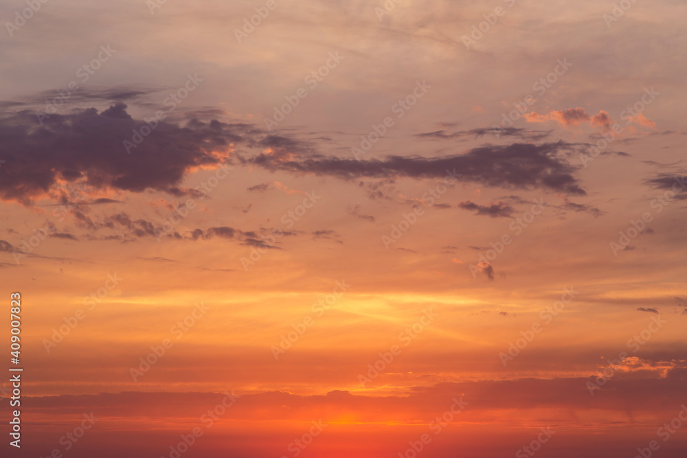 Soft sunrise, sunset red yellow orange sky in sunlight with clouds background texture
