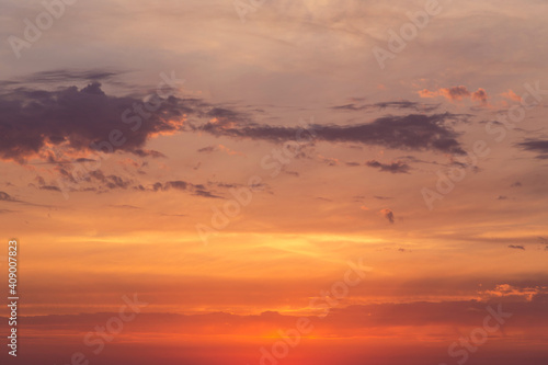 Soft sunrise  sunset red yellow orange sky in sunlight with clouds background texture