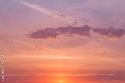 Sunrise, sunset pink violet orange blue sky with sun and sunlight, cirrus clouds background texture	
