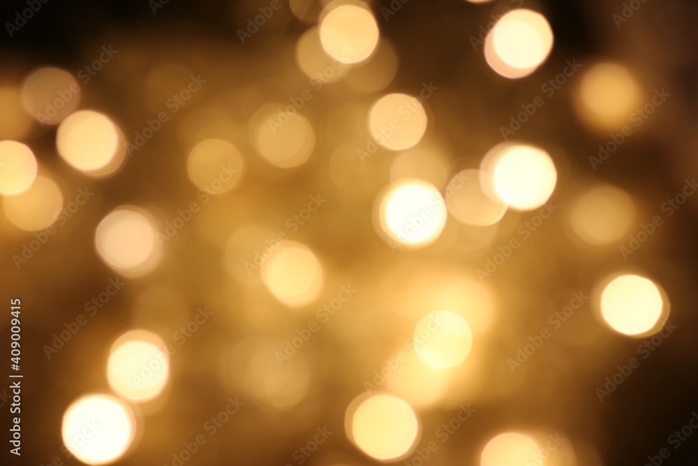 Golden bright glow bokeh. Christmas vintage lights on black background. Colorfull blurred abstract defocused .