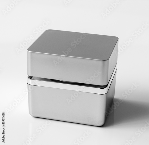 Gray square plastic jar of cream on a light background