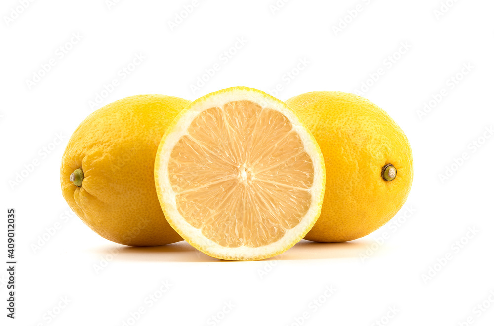 Half a lemon and two whole fruits on a white background. Half a lemon and two whole fruits on a white background.