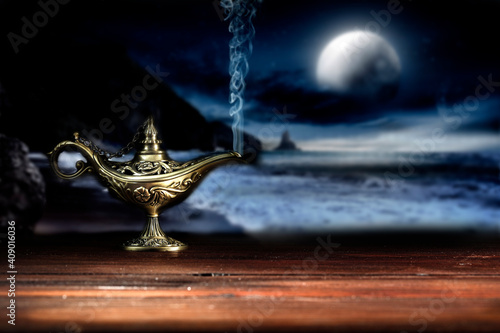 Magic lamp on a wooden table in the dark night 