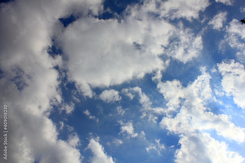 Fototapeta premium Beautiful white clouds on blue sky bottom view.