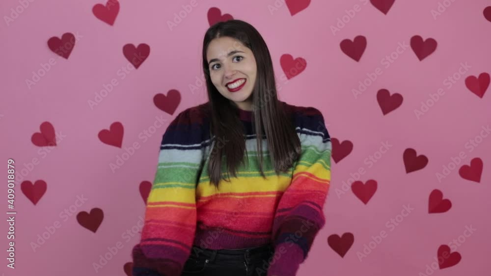 Young beautiful woman very happy making a heart in the air with fingers Young beautiful woman very happy making a heart in the air with fingers