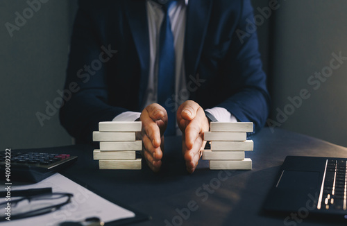 Obraz na plátně Businessman separates wooden block