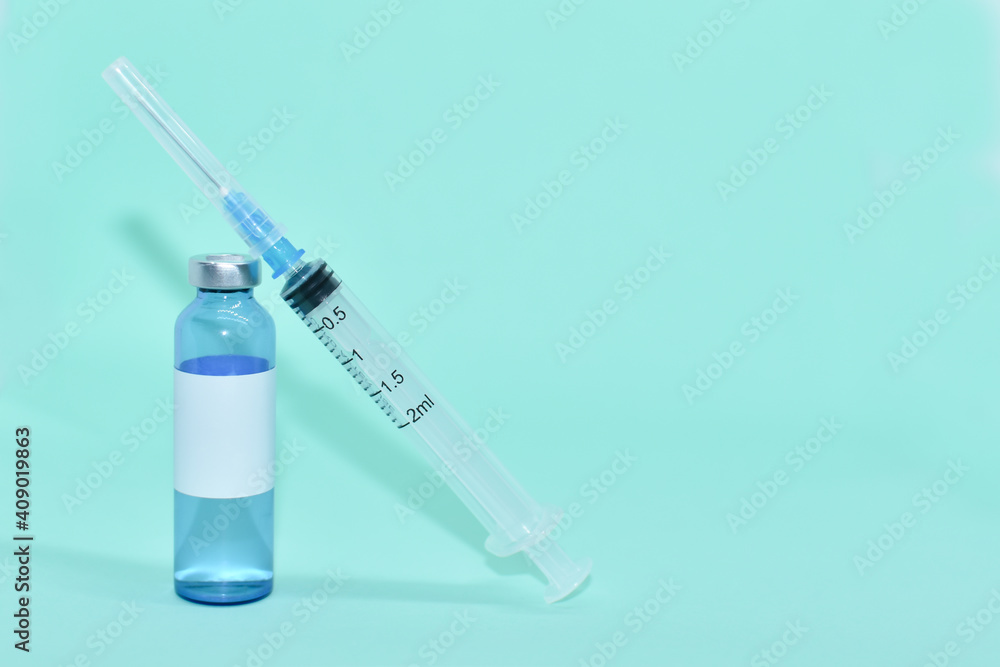 Medical ampoule (vial) with vaccine and syringe on light blue background. White label on bottle, space for text. vaccination against covid-19, flu. Cosmetological injections. COVID-19 vaccine vial Medical ampoule (vial) with vaccine and syringe on light blue background. White label on bottle, space for text. vaccination against covid-19, flu. Cosmetological injections. COVID-19 vaccine vial