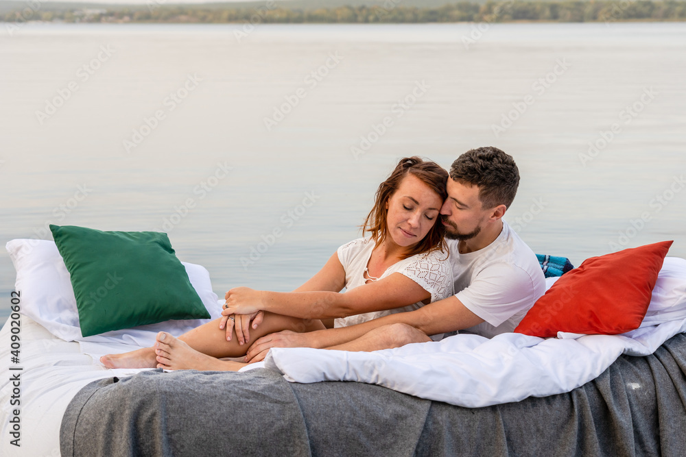 Lovely couple lounging on the floating bed in lake Lovely couple lounging on the floating bed in lake