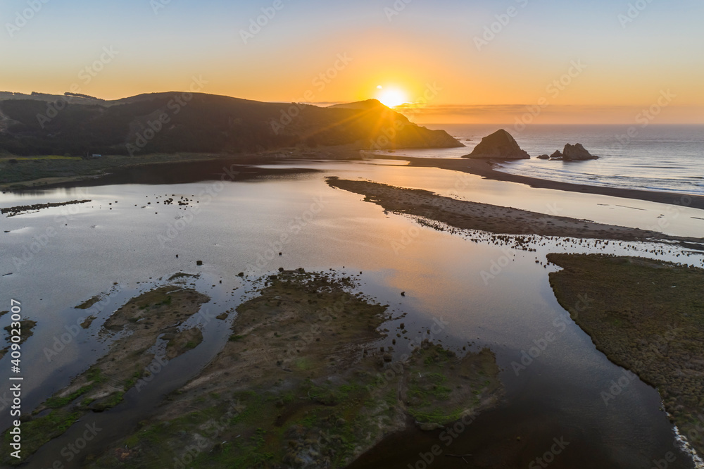Amazing aerial view of a dreamlike beach in the central Chilean coast. Striking view of the waves coming from the sea and the wild coastline. A tranquil scenery in Topocalma beach during sunset time