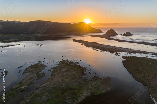 Amazing aerial view of a dreamlike beach in the central Chilean coast. Striking view of the waves coming from the sea and the wild coastline. A tranquil scenery in Topocalma beach during sunset time
