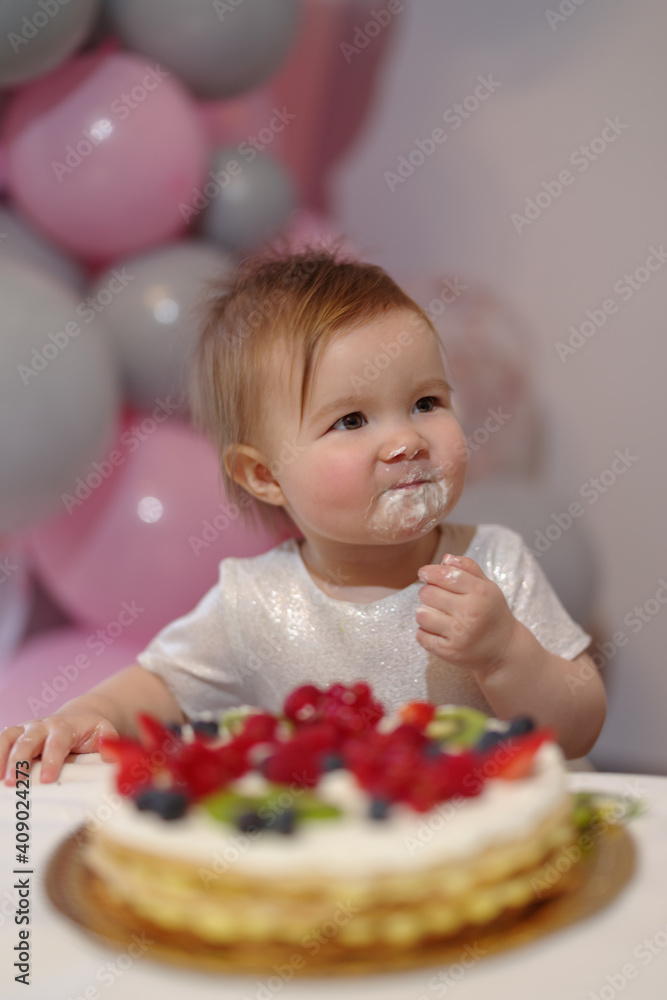 Baby girl on her first birthday with cake Baby girl on her first birthday with cake
