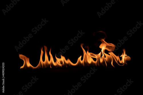 Abstract blaze fire flame texture for banner background.Texture of fire flames on a black background. Real fiery bonfire for creative design elements