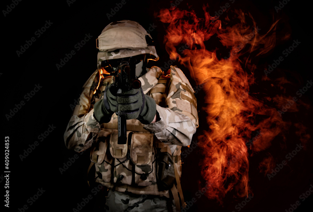 a soldier on fire holding a gun. Fight against terrorism - obrazy, fototapety, plakaty 