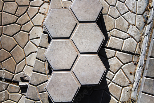 Top view of the hexagonal gray street tile background texture. Honeycomb paving slabs.