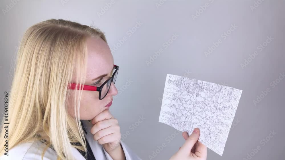 A neurologist examines an encephalogram of a patient’s brain. Schedule of electroencephalograms study of brain currents for signs of epilepsy and pathologies of the nervous system A neurologist examines an encephalogram of a patient’s brain. Schedule of electroencephalograms study of brain currents for signs of epilepsy and pathologies of the nervous system
