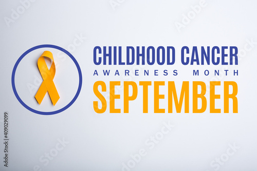 Childhood cancer awareness month. September. Yellow handmade awareness paper ribbon on white background.