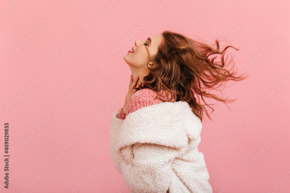 Inspired brunette woman dancing on pink background. Studio shot of active curly girl. Inspired brunette woman dancing on pink background. Studio shot of active curly girl.